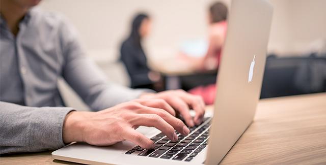 Person typing on a laptop computer